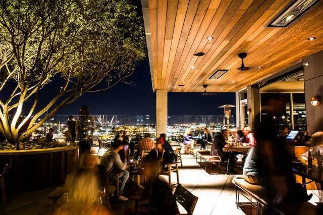 A stylish rooftop bar with city views at Thompson Nashville, a luxury hotel in Tennessee.