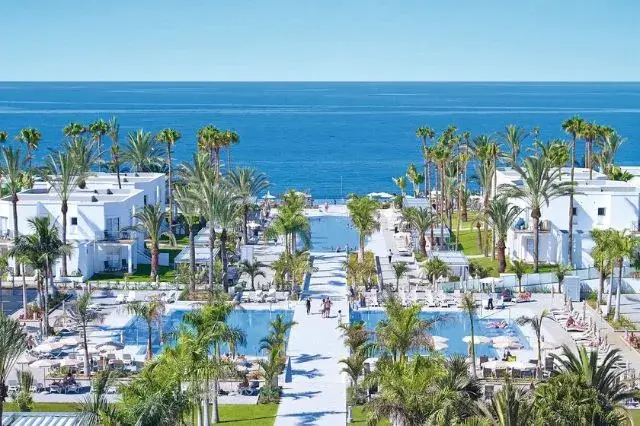 Hotel Riu Palace Meloneras showcasing its luxury amenities, including outdoor pools, sophisticated architecture, and beautiful coastal views in Gran Canaria